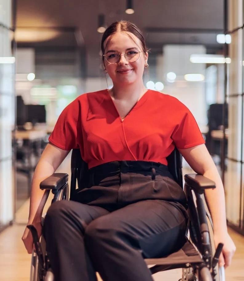 Happy woman in wheelchair smiling at camera