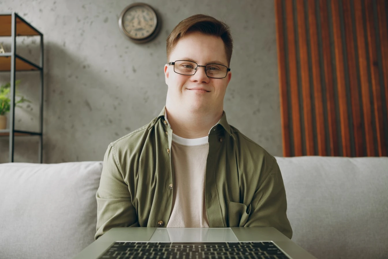 Happy disabled man with down syndrome smiling at camera